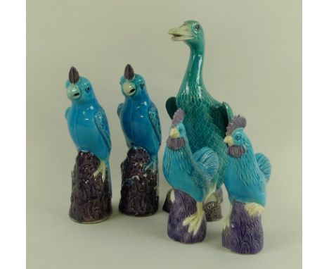 A group of modern Chinese turquoise glazed ceramic figurines, comprising a duck, 25cm, a pair of parrots, 20cm, and a pair of