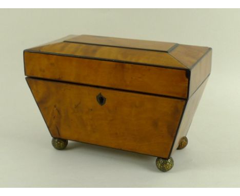 A mid 19th century burr yew tea caddy, of sarcophagus form with ebony stringing and shield lockplate, internally veneered wit
