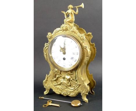 An early 20th century Art Nouveau brass mantel clock, the body chased and embossed with a central female figure in flowing ve