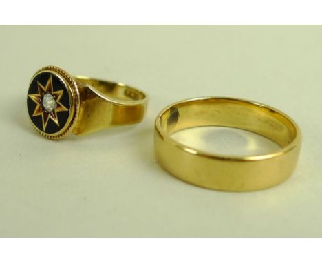 An 18ct gold memorial ring, the central, oval with black enamel starburst setting to central old cut diamond, size K, togethe