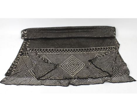 Vintage Textiles: a 1920's Assuit shawl, the black net ground decorated with hammered silver in a geometric design with deep 