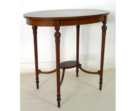 An early 20th century mahogany, crossbanded and inlaid occasional table, with oval surface, lower tier shelf on shaped suppor