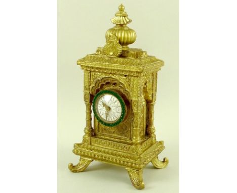 An unusual late 19th / early 20th century Arabic clock, the body elaborately cast and gilded with Moroccan or Arabic architec