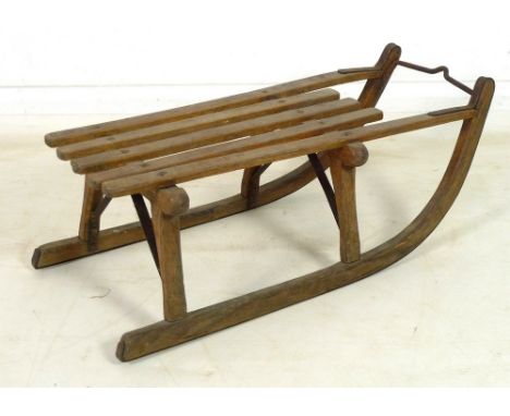 A Swiss toboggan, wooden frame with iron mounts, metal plaque inscribed Herr Mulberg, Dresden, the body later inscribed 'Bull