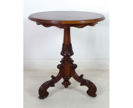 A Victorian mahogany and burr walnut veneered circular occasional table, with turned and carved column, raised on foliate car