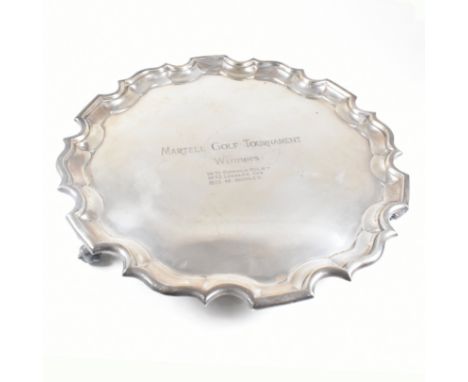 An Edward VII hallmarked Irish silver salver. The salver having four scrolled hoof feet rising to tray with stepped serpentin