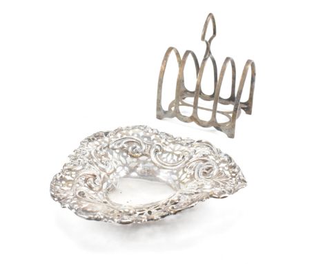 A hallmarked silver toast rack and trinket dish. The Victorian trinket dish having a heart shaped form with pierced repousse 