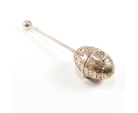 A Victorian hallmarked silver tea infuser of egg form.The infuser having an egg shaped pierced infuser suspended upon a silve