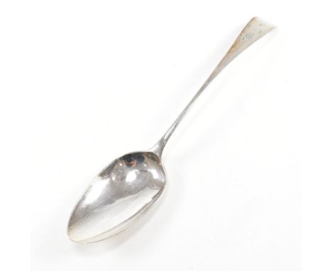 A Georgian hallmarked silver serving spoon. The George V spoon having a fiddle pattern decoration and letters inscribed to te