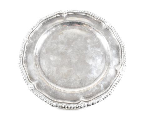 A Victorian Irish hallmarked silver salver. The salver having a stepped rim with serpentine edge, raising to a moulded scroll