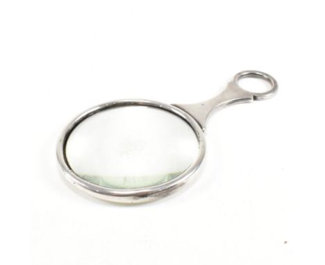 A George VI Hallmarked silver magnifying eye glass. The eye glass&nbsp;having a circular silver mounted glass and loop handle