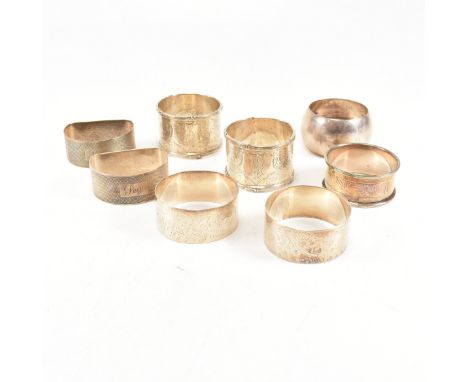 A collection of eight hallmarked silver napkin rings. The lot to include a pair with etched scrolled design and central monog