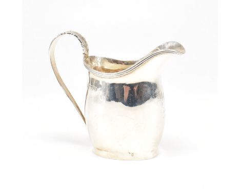 An Edward VII Hallmarked silver creamer. The cream jug having an oval foot base raising to a bulbous form etched with central