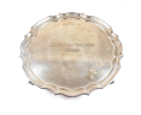 A mid century hallmarked silver salver. The salver having four hoof feet rising to tray with stepped serpentine rim. The salv