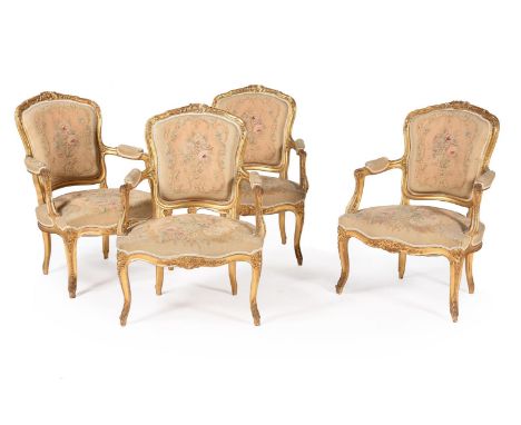 A set of four giltwood fauteuils in Louis XV style, 19th century, with flower and scroll woven tapestry upholstery, each 92.5