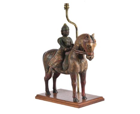 An Asian polychrome painted wood figure on horse back, in the manner of Tang pottery examples, later mounted on an oak lamp b