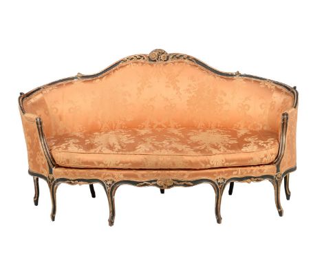 A Louis XV carved giltwood and painted sofa, third quarter 18th century, upholstered in orange silk damask and raised on cabr