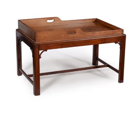 A mahogany butler's tray on stand, the tray circa 1800, the shaped sides pierced with handles, the stand later, 61cm high, 95