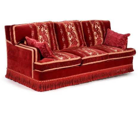 A three seat sofa, modern, supplied by Toni Facella, upholstered in crimson cut-velvet with gold and crimson piping and with 