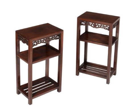 A pair of Chinese hardwood three tier occasional tables or stands, early 20th century, each with a pierced frieze, 79cm high,