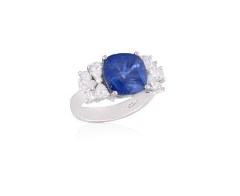 A SAPPHIRE AND DIAMOND RINGThe cushion-shaped sapphire weighing approximately 8.00cts, within a four-claw setting and between