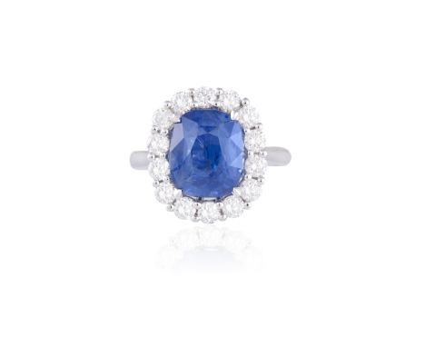 A SAPPHIRE AND DIAMOND CLUSTER RINGThe cushion-shaped sapphire weighing 4.56cts, within a surround of round brilliant-cut dia