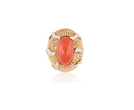 A CORAL AND DIAMOND DRESS RING, CIRCA 1960The bombé domed mount of ropetwist design, set to the centre with an oval-shaped ca