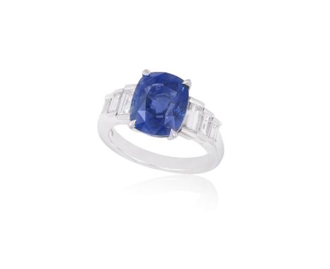 A SAPPHIRE AND DIAMOND RINGThe cushion-shaped sapphire weighing 6.02cts  within a four-claw setting, between tapered shoulder