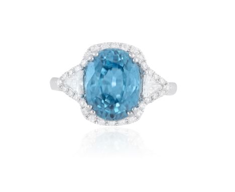 A ZIRCON AND DIAMOND RINGThe oval-shaped blue zircon weighing approximately 5.50cts, between trillion-cut diamond shoulders w