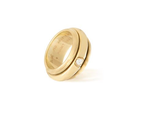 A GOLD AND DIAMOND POSSESSION RING, BY PIAGET, 1993Designed as a rotating band set with a brilliant-cut diamond highlight and
