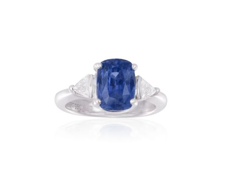 A SAPPHIRE AND DIAMOND RINGThe  cushion-shaped sapphire weighing approximately 4.60cts, within a four-claw setting and betwee