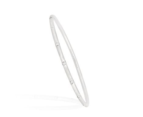 A DIAMOND BANGLE, BY TIFFANY &amp; CO.The thin hoop accented with round brilliant-cut diamonds throughout, in 18K gold, signe