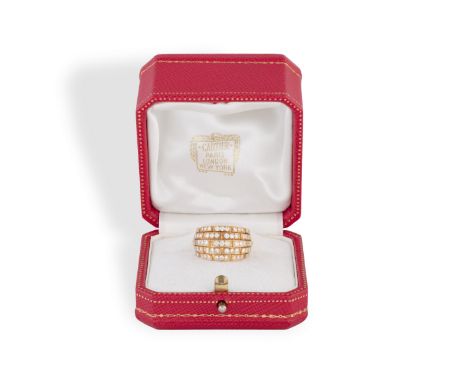 A DIAMOND ORIANE RING, BY CARTIERThe large band with diamond-set sections to the bombé style front, mounted in 18K gold, diam