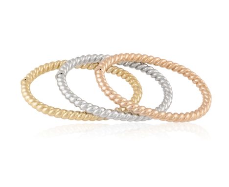 A TRIO OF GOLD BANGLE BRACELETSComposed of three hinged gold bracelets with twisted reeded detailing, in 18K rose, white and 