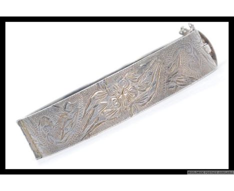 A silver 925 collar bangle being chased with foliate design being hallmarked for NW 925, date letter A. Total weight 31g