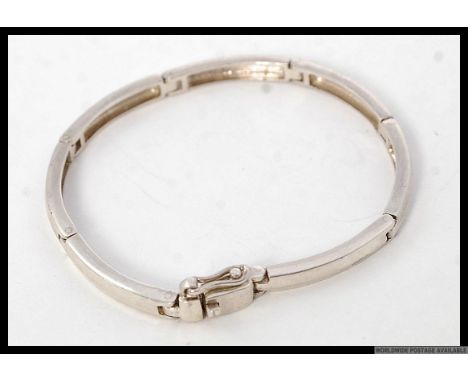 A contemporary ladies curb linked bracelet bangle. Stamped makers IM 925. Total weight 13.1g