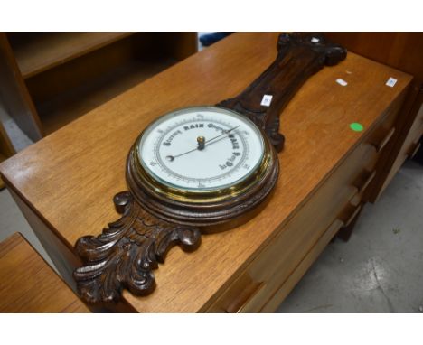 A traditional barometer, oak case, missing thermometer dial