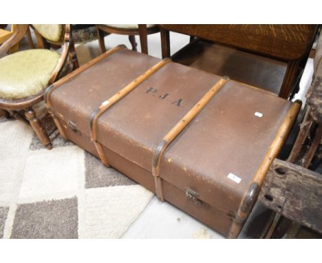 A vintage travel trunk, bearing monogram PJA