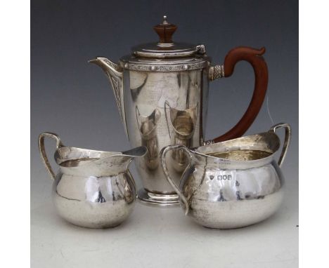 Hammered silver oval milk jug and sugar basin, Haseler Bros, London 1912; a silver coffee pot with celtic decoration and comp