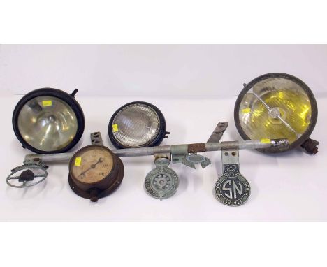 Two car lights one by Marschal and a motorcycle light, car badge bar with four driving club badges, also a pressure gauge. Co