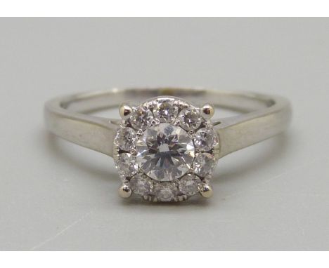An 18ct white gold brilliant cut diamond ring, 3.4g, O, colour EF, clarity VVS, eleven diamonds in total, with 2014 insurance