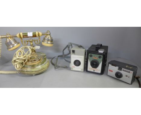 An onyx telephone, a Consul Brownie type camera and two other cameras 