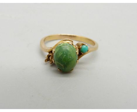 A yellow metal and turquoise ring, control marks on the outside of the shank, lacking one stone, 3.1g, N 