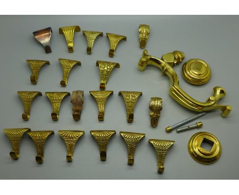 A brass door knocker and twenty brass picture rail hangers 