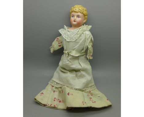 A circa 1900 doll with bisque head and soft body, lacking arms, 24cm 