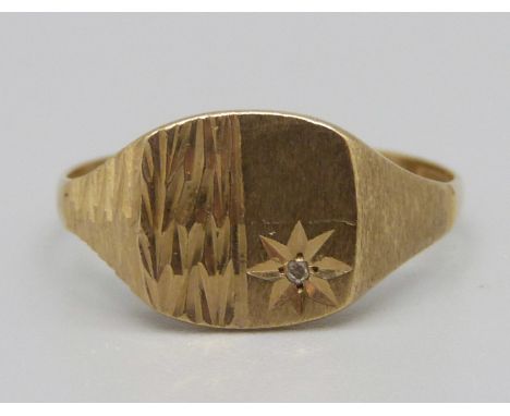 A 9ct gold signet ring set with a diamond, 2.1g, U 