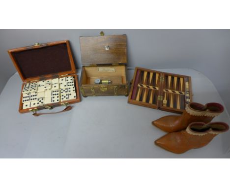 Travel dominoes, a musical box, travel backgammon and a small pair of leather cowboy boots 