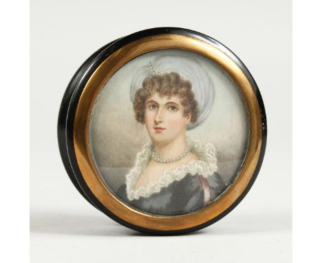 A GEORGIAN EBONY CIRCULAR BOX, the top painted with a portrait of a young lady wearing pearls. 3ins diameter.