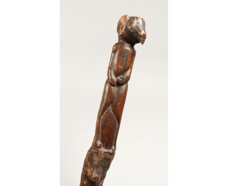 A CARVED FOLK ART STICK 36ins long