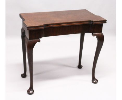 A GEORGE III MAHOGANY FOLD OVER CARD TABLE with a shaped rectangular top, green beize lining with counter wells/glass stands,